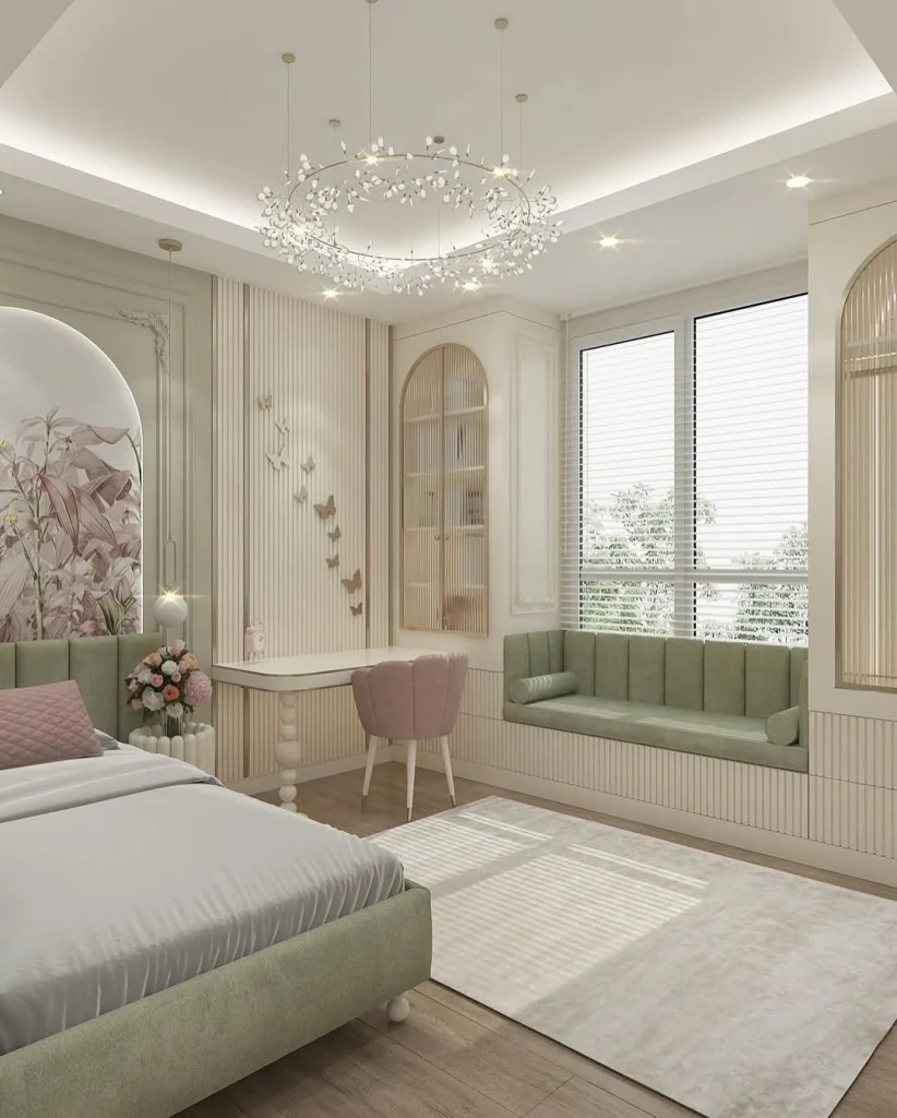 Sage green and blush girl's bedroom with fluted wall panelling, arched wardrobes, and butterfly wall art
