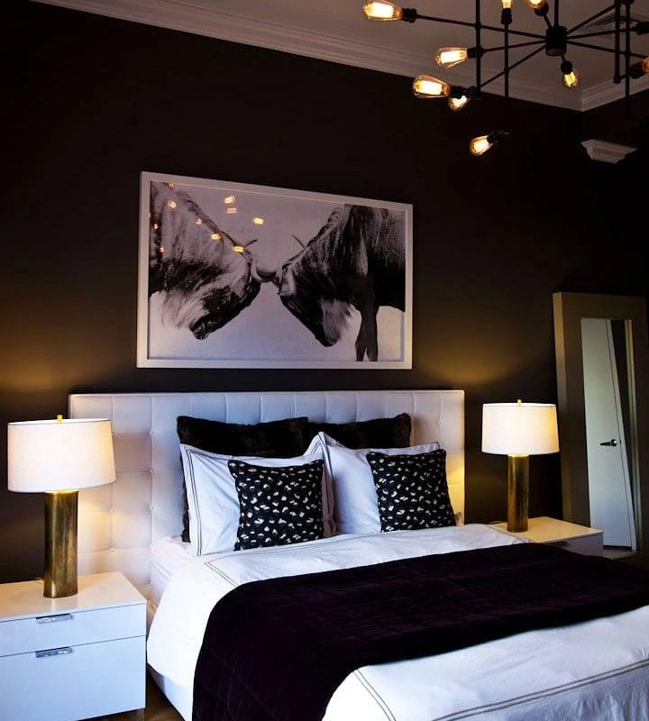 Dark near-black bedroom with white tufted leather headboard