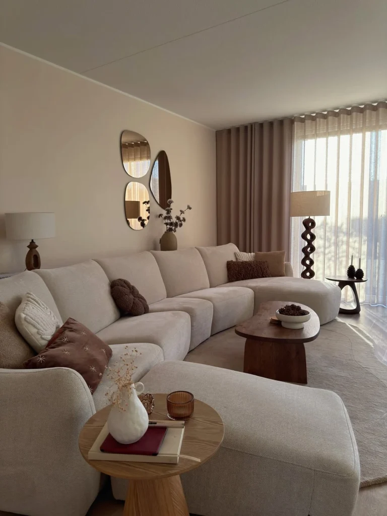 Warm neutral living room with curved cream modular sofa