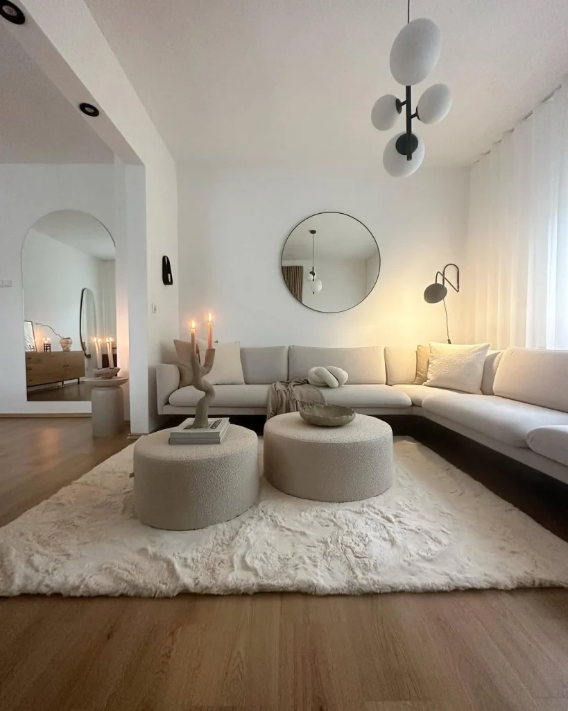 Minimalist white living room with boucle ottomans