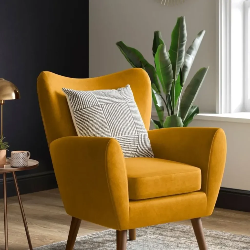 Mustard yellow velvet wingback accent chair on walnut legs with copper lamp