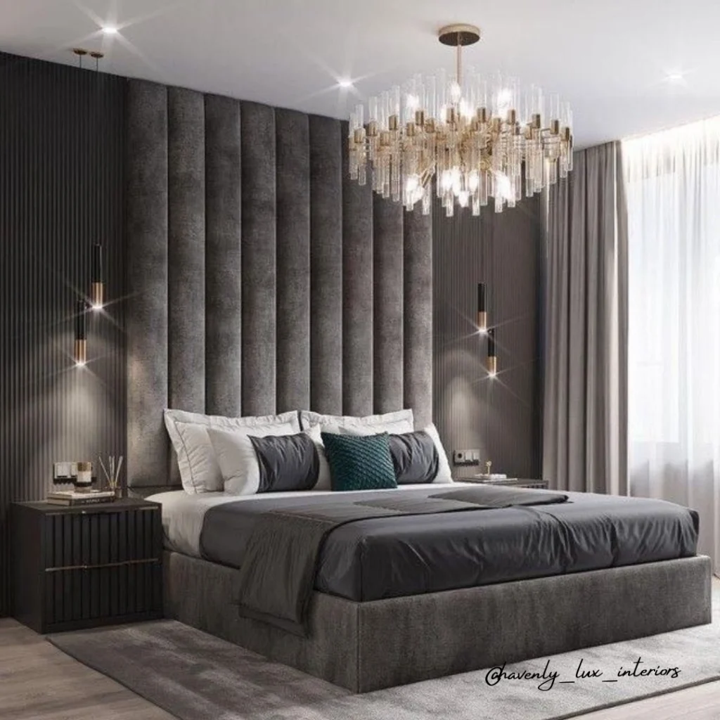 Glamorous dark grey bedroom with floor-to-ceiling channeled velvet headboard wall