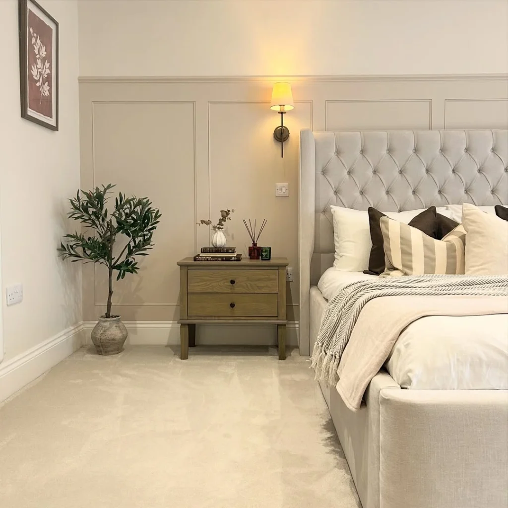 Warm greige neutral bedroom with lower wall paneling
