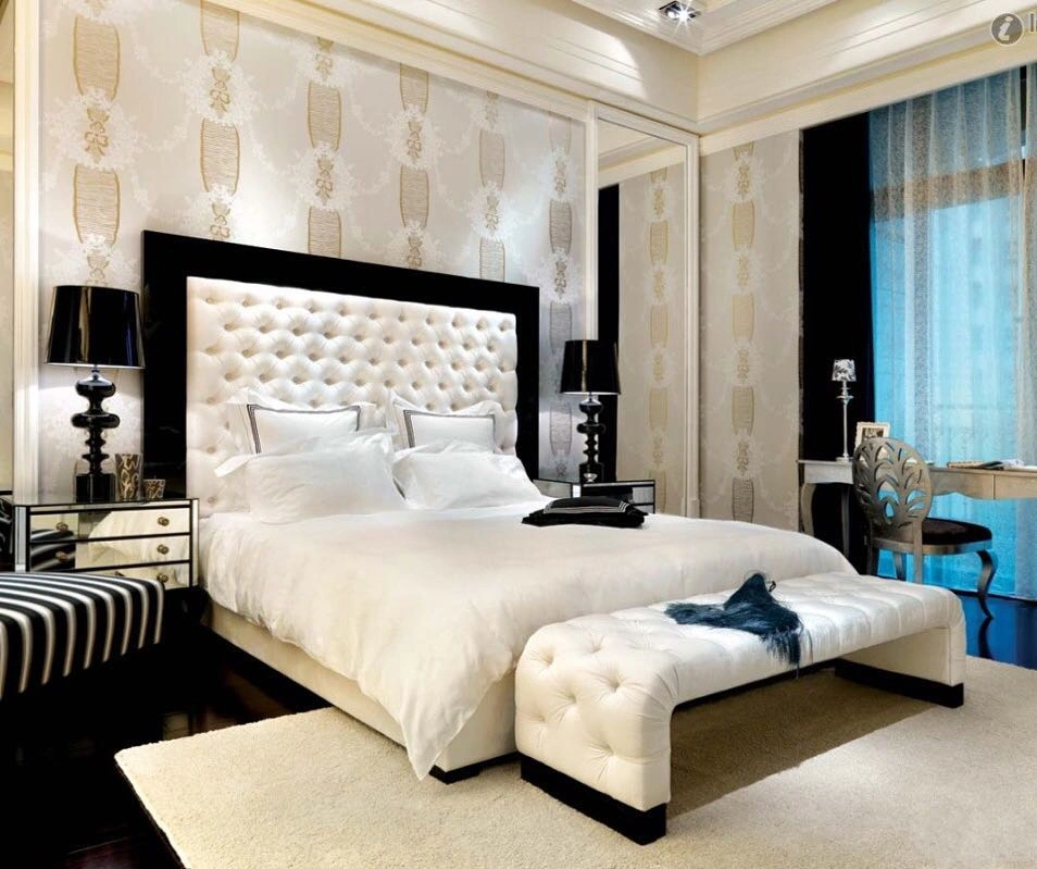 Classic luxury couple's bedroom with tall white tufted leather headboard in black lacquer frame